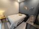 Cozy bedroom featuring a sleeper sofa bed, wooden Florida decor and gray ceramic tile flooring at 4300 Barletta Ct, Wesley Chapel, FL 33543