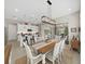 Dining area with a wood table, white chairs, and views of the kitchen and living room at 4300 Barletta Ct, Wesley Chapel, FL 33543