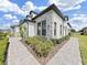 Beautiful exterior corner of the home with stone accents, manicured bushes, and a brick walkway at 4300 Barletta Ct, Wesley Chapel, FL 33543