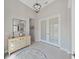 Spacious foyer with a decorative cabinet, round rug, and double doors, creating an inviting entrance at 4300 Barletta Ct, Wesley Chapel, FL 33543