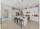 Kitchen featuring white cabinets, stainless steel appliances, a center island with bar stools, and pendant lighting at 4300 Barletta Ct, Wesley Chapel, FL 33543