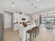 Bright kitchen featuring stainless steel appliances, a white island with seating, and pendant lighting at 4300 Barletta Ct, Wesley Chapel, FL 33543
