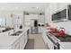 White kitchen with stainless steel appliances and subway tile backsplash at 4300 Barletta Ct, Wesley Chapel, FL 33543