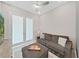 Comfortable living room features a ceiling fan, cozy sofa, and ottoman at 4300 Barletta Ct, Wesley Chapel, FL 33543