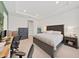 Bright main bedroom features a king bed, brick accent wall and ample space for a home office at 4300 Barletta Ct, Wesley Chapel, FL 33543