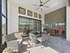 Charming screened-in patio with comfortable seating, outdoor dining, ceiling fan, and an outdoor grill at 4300 Barletta Ct, Wesley Chapel, FL 33543