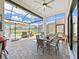 Screened patio with outdoor dining, seating, and lake views, perfect for enjoying the outdoors at 4300 Barletta Ct, Wesley Chapel, FL 33543
