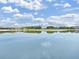 Scenic view of the pond, reflecting the clear blue sky and surrounding trees and homes at 4300 Barletta Ct, Wesley Chapel, FL 33543