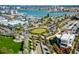 Aerial view of a scenic coastal community showcasing the lush landscaping, roundabout, and waterfront access at 445 Hamden Dr # 502, Clearwater Beach, FL 33767