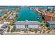 Stunning aerial view of waterfront condo building with boat docks and city skyline in the background at 445 Hamden Dr # 502, Clearwater Beach, FL 33767