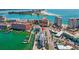 Stunning aerial view of a coastal building with a marina, set against the backdrop of the city skyline and waterfront at 445 Hamden Dr # 502, Clearwater Beach, FL 33767