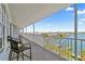 Relaxing covered balcony with seating offers stunning water and city views at 445 Hamden Dr # 502, Clearwater Beach, FL 33767