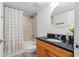 Bathroom with tiled shower and granite vanity with light wood cabinets at 445 Hamden Dr # 502, Clearwater Beach, FL 33767