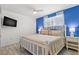 Bright bedroom with a comfortable queen bed, stylish decor, and a wall-mounted TV at 445 Hamden Dr # 502, Clearwater Beach, FL 33767