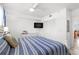 Bright bedroom featuring flat screen TV, double door closet, and coastal decor at 445 Hamden Dr # 502, Clearwater Beach, FL 33767