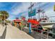 Vibrant boardwalk scene with colorful shops, attractions, and boats, creating a lively waterfront atmosphere at 445 Hamden Dr # 502, Clearwater Beach, FL 33767