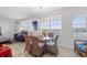 Charming dining room with a glass table, wicker chairs, and natural light from large windows at 445 Hamden Dr # 502, Clearwater Beach, FL 33767