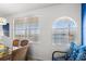 Bright dining area featuring large windows with water views and a coastal-inspired accent chair at 445 Hamden Dr # 502, Clearwater Beach, FL 33767