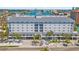 Attractive exterior elevation of the building with balconies, palm trees, and well-maintained landscaping at 445 Hamden Dr # 502, Clearwater Beach, FL 33767