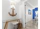 Hallway featuring glass topped desk and doorway to bedroom with blue accent wall at 445 Hamden Dr # 502, Clearwater Beach, FL 33767