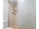 Shower featuring neutral tile, glass doors and shower head with detachable spray at 445 Hamden Dr # 502, Clearwater Beach, FL 33767