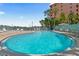 Sparkling swimming pool with lounge chairs and waterfront views, perfect for relaxation and recreation at 445 Hamden Dr # 502, Clearwater Beach, FL 33767