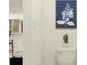 Bright bathroom features floral wall art and a small potted plant on top of the toilet tank at 4511 S Manhattan Ave # 04, Tampa, FL 33611