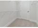 Clean white walk-in closet with built-in shelving, awaiting your personal organization at 4717 W Mccoy St # 2, Tampa, FL 33616