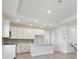 Modern kitchen with an island and stainless steel appliances, open to the living area at 4717 W Mccoy St # 2, Tampa, FL 33616