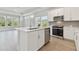 Open-concept kitchen featuring stainless steel appliances, a large island, and an abundance of natural light at 4717 W Mccoy St # 2, Tampa, FL 33616
