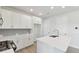 Kitchen features clean white cabinets, quartz countertops, stainless appliances, and wood flooring at 4717 W Mccoy St # 2, Tampa, FL 33616