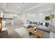 Open-concept living area featuring a modern kitchen and comfortable seating on a stylish patterned rug at 4717 W Mccoy St # 2, Tampa, FL 33616
