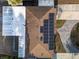 An aerial view of a house with solar panels on the roof at 4721 W Iowa Ave, Tampa, FL 33616