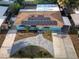 Aerial view of a blue house with solar panels and a paved driveway at 4721 W Iowa Ave, Tampa, FL 33616