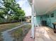 View of the backyard and covered patio including a ladder and outdoor utilities at 4721 W Iowa Ave, Tampa, FL 33616