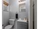 This bathroom features a gray vanity and a square mirror at 4721 W Iowa Ave, Tampa, FL 33616