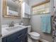 This bathroom features a blue vanity and a framed mirror at 4721 W Iowa Ave, Tampa, FL 33616