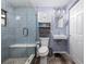 Updated bathroom featuring a sleek glass-enclosed shower, floating sink, and modern fixtures at 4721 W Iowa Ave, Tampa, FL 33616