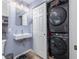 Bathroom view featuring stacked washer/dryer units, vanity, modern lights, and stylish fixtures at 4721 W Iowa Ave, Tampa, FL 33616