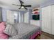 Comfortable bedroom with ceiling fan, white closets and shelving, with easy bathroom access at 4721 W Iowa Ave, Tampa, FL 33616