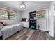 Bright bedroom featuring two windows, dresser, and open light fixture at 4721 W Iowa Ave, Tampa, FL 33616