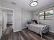 This bedroom features wood flooring, a window, and a bed at 4721 W Iowa Ave, Tampa, FL 33616