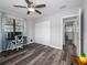 This bedroom features wood flooring, a ceiling fan, and a closet at 4721 W Iowa Ave, Tampa, FL 33616
