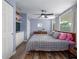 Cozy bedroom featuring a large window, ceiling fan, and a comfortable bed with ample pillows at 4721 W Iowa Ave, Tampa, FL 33616