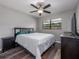Bedroom featuring a modern ceiling fan, a comfy bed, and a stylish dresser at 4721 W Iowa Ave, Tampa, FL 33616