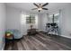 This bedroom features wood flooring, a ceiling fan, and plenty of natural light at 4721 W Iowa Ave, Tampa, FL 33616
