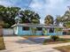 Charming single-story home with a neatly paved driveway and lush, well-manicured landscaping at 4721 W Iowa Ave, Tampa, FL 33616
