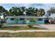 Charming home featuring a tidy front yard, new driveway, and bright yellow front door at 4721 W Iowa Ave, Tampa, FL 33616