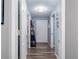 Hallway leading to the front door with wood-look flooring and neutral wall color at 4721 W Iowa Ave, Tampa, FL 33616