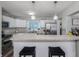 Modern kitchen featuring white cabinets, stone counters, and stainless steel appliances at 4721 W Iowa Ave, Tampa, FL 33616